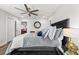 Bedroom featuring wood flooring, a ceiling fan, and a bed with decorative pillows at 5809 Alabaster Stone Ln, Apollo Beach, FL 33572