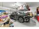 Spacious two car garage with a black SUV parked inside at 5809 Alabaster Stone Ln, Apollo Beach, FL 33572