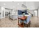 Open concept kitchen and dining area with modern lighting and stainless appliances at 5809 Alabaster Stone Ln, Apollo Beach, FL 33572