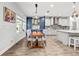 Open kitchen features custom cabinets, stainless appliances, a dining area and a kitchen island at 5809 Alabaster Stone Ln, Apollo Beach, FL 33572