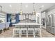 Gourmet kitchen features a gray island bar, stainless appliances, and custom cabinets at 5809 Alabaster Stone Ln, Apollo Beach, FL 33572
