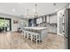 Bright open kitchen with a gray kitchen island bar and stainless steel appliances at 5809 Alabaster Stone Ln, Apollo Beach, FL 33572