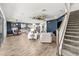 Open concept living space with tile floors and staircase next to the kitchen area at 5809 Alabaster Stone Ln, Apollo Beach, FL 33572