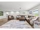 Spacious living room with leather furniture and a large patterned rug at 5809 Alabaster Stone Ln, Apollo Beach, FL 33572