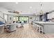 Open floor plan with kitchen island bar, living room and dining area at 5809 Alabaster Stone Ln, Apollo Beach, FL 33572