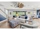 Comfortable living room with stylish furnishings and view to outdoor patio and pool at 5809 Alabaster Stone Ln, Apollo Beach, FL 33572