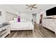Nicely staged main bedroom showcasing hardwood floors, a ceiling fan, and a relaxing atmosphere at 5809 Alabaster Stone Ln, Apollo Beach, FL 33572