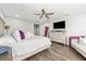 Serene main bedroom with hardwood floors, a decorative ceiling fan, and ample space for relaxation and comfort at 5809 Alabaster Stone Ln, Apollo Beach, FL 33572