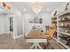 This home office features a chandelier, wood-look flooring, and a glass paneled door at 5809 Alabaster Stone Ln, Apollo Beach, FL 33572