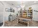 This office features wood-look flooring, a desk, chair, and a custom built-in bookshelf at 5809 Alabaster Stone Ln, Apollo Beach, FL 33572