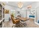 Bright home office with wood-look flooring, chandelier, desk and comfortable chair at 5809 Alabaster Stone Ln, Apollo Beach, FL 33572