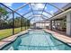 Beautiful screened-in pool with an entertainment area at 5809 Alabaster Stone Ln, Apollo Beach, FL 33572