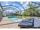 Relaxing screened-in pool with brick patio and lounge chairs at 5809 Alabaster Stone Ln, Apollo Beach, FL 33572