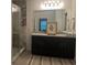 Modern bathroom features double sinks, a granite countertop and a glass shower stall at 626 Diamond Ridge Rd, Seffner, FL 33584