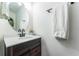 Bright bathroom featuring a wood vanity, modern fixtures, and a neutral color scheme, creating a relaxing and clean space at 626 Diamond Ridge Rd, Seffner, FL 33584