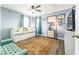 Bright bedroom features a daybed with trundle, stylish decor, and wood-look floors at 626 Diamond Ridge Rd, Seffner, FL 33584