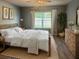Cozy bedroom with a large window and natural light and rustic decor at 626 Diamond Ridge Rd, Seffner, FL 33584