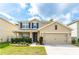 Charming two-story home featuring a well-maintained lawn, an attached two-car garage, and a classic design at 626 Diamond Ridge Rd, Seffner, FL 33584