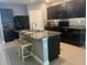 Modern kitchen featuring dark cabinetry, granite countertops, a kitchen island, and stainless steel appliances at 626 Diamond Ridge Rd, Seffner, FL 33584