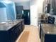Modern kitchen featuring dark cabinetry, granite countertops, and stainless steel appliances at 626 Diamond Ridge Rd, Seffner, FL 33584