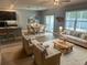Open-concept living room and kitchen area with modern furniture and abundant natural light at 626 Diamond Ridge Rd, Seffner, FL 33584