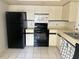 Efficient kitchen featuring black appliances and ample cabinet space at 6304 Pointe West Blvd # A206, Bradenton, FL 34209