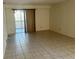 Spacious living room with tiled floor, neutral walls, and sliding door access to a balcony at 6304 Pointe West Blvd # A206, Bradenton, FL 34209