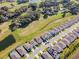 An aerial view shows the home's location in a neighborhood with a pond and golf course at 6426 Bradford Woods Dr, Zephyrhills, FL 33542