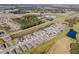 Panoramic aerial shot featuring a residential neighborhood with golf course views and recreational facilities at 6426 Bradford Woods Dr, Zephyrhills, FL 33542