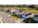 Neighborhood aerial view featuring a pond, golf course, and homes with solar panels at 6426 Bradford Woods Dr, Zephyrhills, FL 33542
