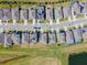 Aerial view of homes in a residential area, some with solar panels, bordering a scenic golf course at 6426 Bradford Woods Dr, Zephyrhills, FL 33542