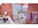 Bathroom with walk-in tub, tiled walls, and a single sink vanity at 6426 Bradford Woods Dr, Zephyrhills, FL 33542