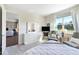 Bright bedroom with serene view, neutral tones, and comfortable sitting area at 6426 Bradford Woods Dr, Zephyrhills, FL 33542