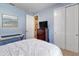 View of the bedroom showing the closet, desk and dresser with TV on top at 6426 Bradford Woods Dr, Zephyrhills, FL 33542