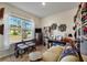Bright bedroom with ample workspace, natural light, and views of the outdoors at 6426 Bradford Woods Dr, Zephyrhills, FL 33542