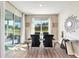 Dining room with elegant table, chairs, mirrored console, and view of the backyard at 6426 Bradford Woods Dr, Zephyrhills, FL 33542