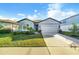 Charming single-story home with a well-manicured lawn and a two-car garage at 6426 Bradford Woods Dr, Zephyrhills, FL 33542