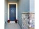 Inviting front entrance with a modern blue door and decorative stone accents at 6426 Bradford Woods Dr, Zephyrhills, FL 33542