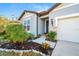 Charming home exterior with stone accents, a well-manicured lawn, and a welcoming front entrance at 6426 Bradford Woods Dr, Zephyrhills, FL 33542