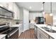 Modern kitchen featuring stainless steel appliances, white cabinetry, and a stylish backsplash at 6426 Bradford Woods Dr, Zephyrhills, FL 33542