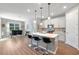 Bright kitchen featuring a center island with seating, white cabinets, and stainless steel appliances at 6426 Bradford Woods Dr, Zephyrhills, FL 33542