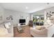 Comfortable living room featuring neutral-toned sofas and a glass coffee table at 6426 Bradford Woods Dr, Zephyrhills, FL 33542