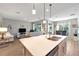 Open-concept kitchen, dining and living room space with sliding glass doors to the patio at 6426 Bradford Woods Dr, Zephyrhills, FL 33542