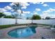 Enjoy a private backyard oasis with a pool, lounge chairs, and a white fence for privacy at 6513 14Th W Ave, Bradenton, FL 34209