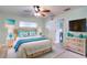 Light-filled main bedroom with beachy-themed decor and a cooling ceiling fan at 6513 14Th W Ave, Bradenton, FL 34209