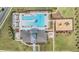 Top-down aerial perspective of a recreational area including a pool, clubhouse, playground, and well-designed green spaces at 6748 Ripple Pond Loop, Zephyrhills, FL 33541