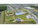 High-angle aerial view showcasing community amenities such as a pool, clubhouse, playground, and landscaped grounds at 6748 Ripple Pond Loop, Zephyrhills, FL 33541
