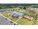 Aerial shot of community amenities featuring a pool, clubhouse, playground, sports courts, and beautifully landscaped areas at 6748 Ripple Pond Loop, Zephyrhills, FL 33541