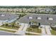 Scenic aerial view of townhomes boasting tidy landscaping, individual driveways, and lovely architectural design at 6748 Ripple Pond Loop, Zephyrhills, FL 33541