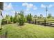 Scenic backyard with a wooden fence and lush green grass at 6748 Ripple Pond Loop, Zephyrhills, FL 33541
